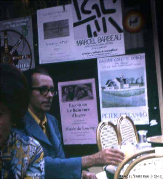 Marcel Barbeau at a Paris bistro after distributing posters for his one man show at the Canadian Cultural Centre in Paris. This poster is pasted on right up side of this bistro window. © Photo Ninon Gauthier.